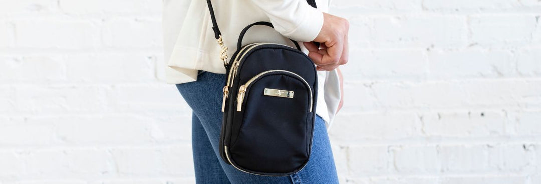 A women wearing a black Diabetes supply triple zip insulated purse that holds all your diabetic supplies and has back insulated pocket.