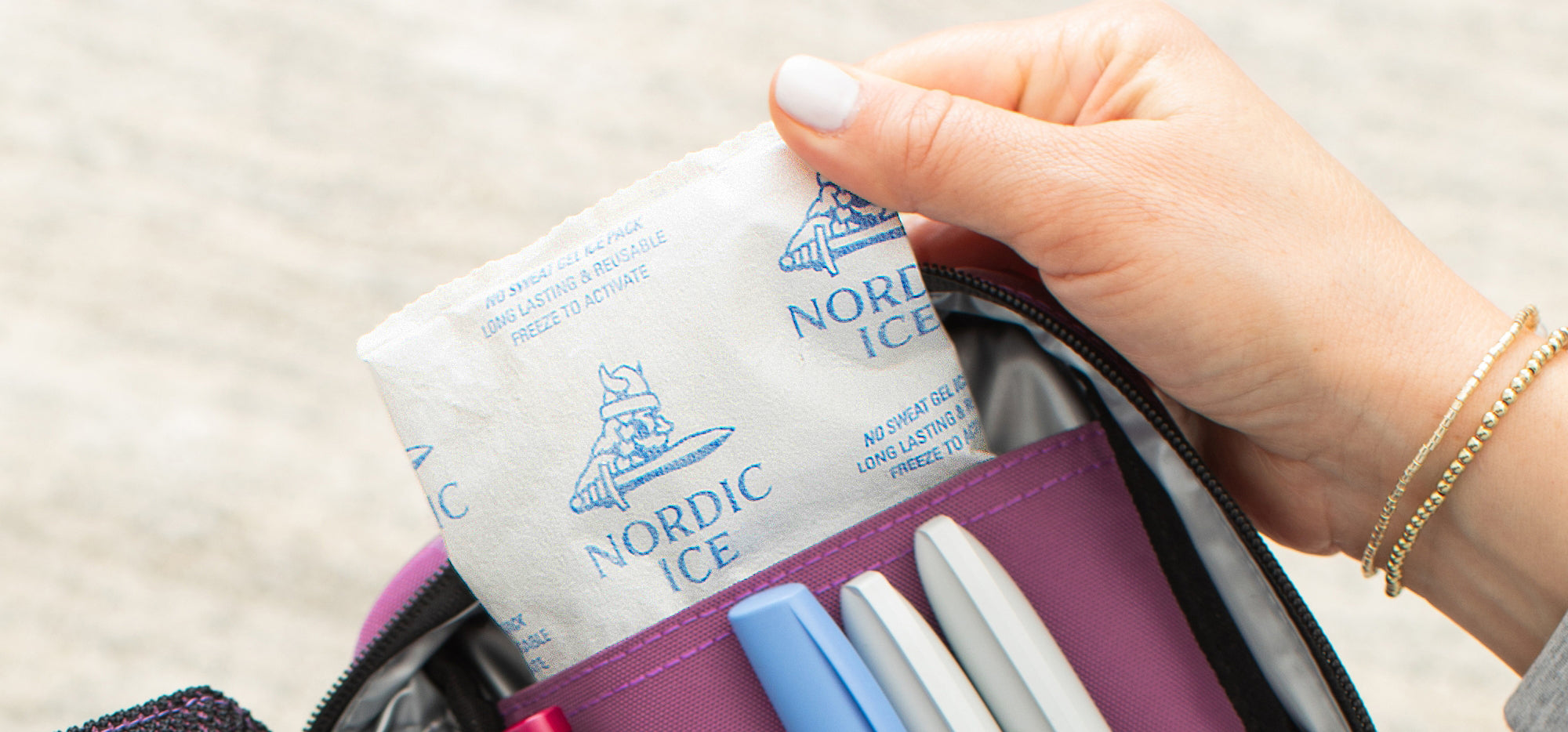 A hand pulling a Nordic Ice Pack out of a Sugar Medical Diabetes organizer that helps keep insulin at the right temperature.