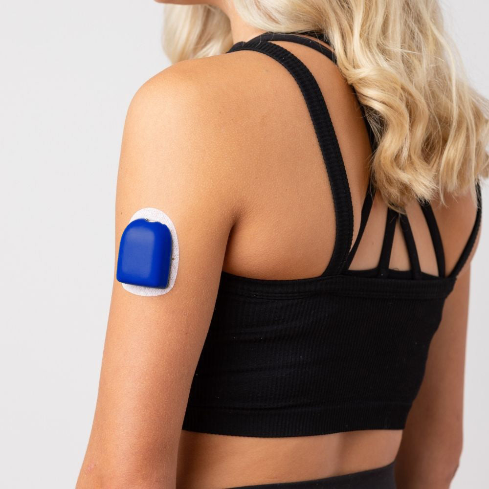 A woman wearing a blue PumpPOP on the outside of her upper left arm