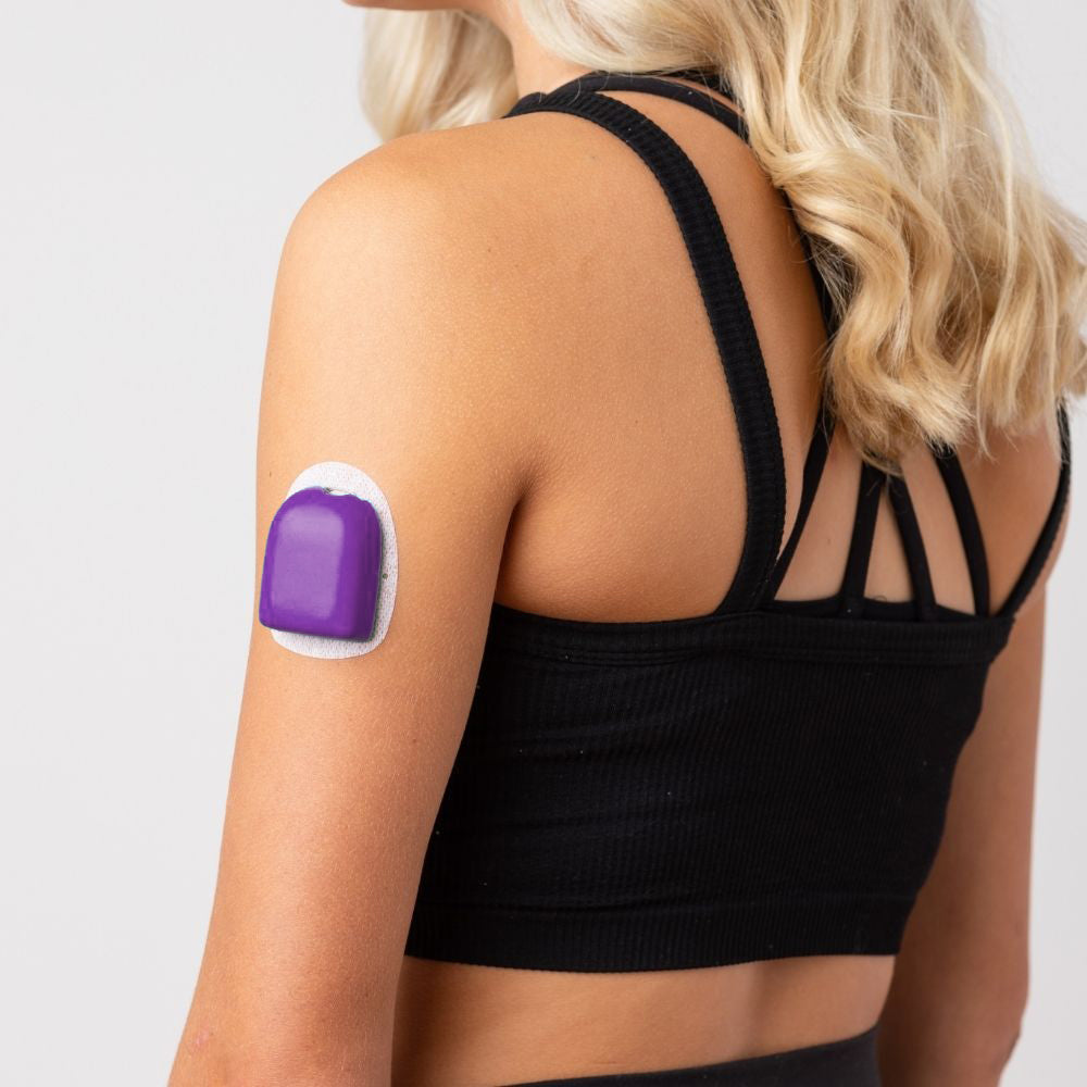 A woman wearing a purple  PumpPOP on the outside of her upper left arm