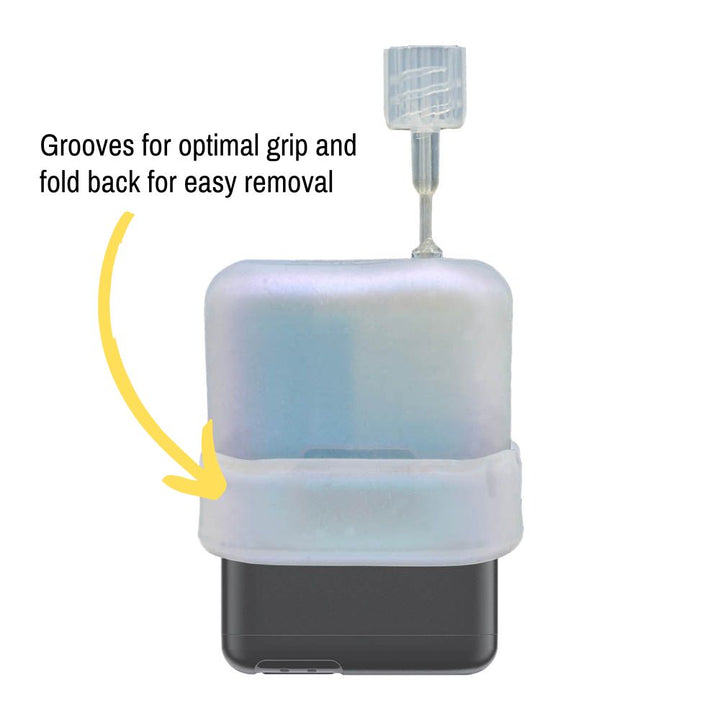 The white shimmer Mobi Tandem Gel Skin pulled up on the insulin pump showing grooves for optimal grip and fold back for easy removal.