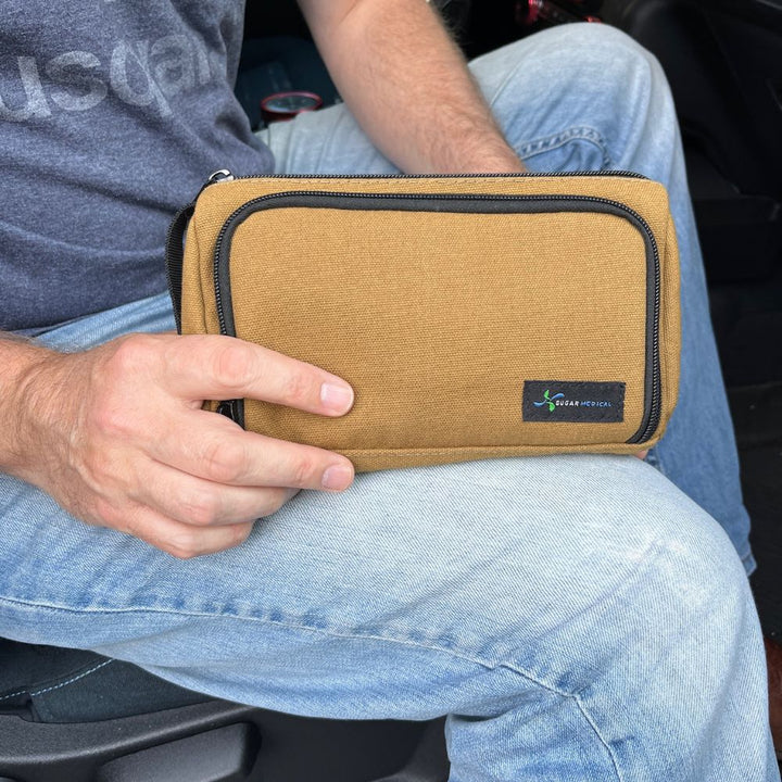 A man holding Insulated Diabetes Insulin Supply Case in Hamilton Brown in his hands.