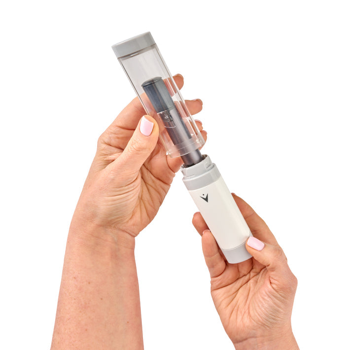 VIVI Cap in hands pulling top off to remove insulin pen.