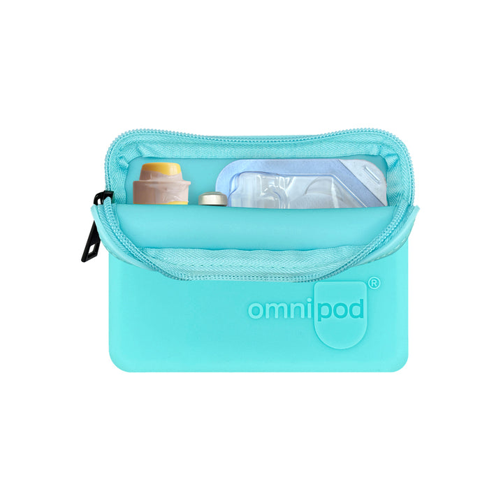 Insulin and Baqsimi nasal glucagon: The interior of the aqua Omnipod® protective travel case showing an insulin vial and a Baqsimi nasal glucagon arranged neatly within the case.