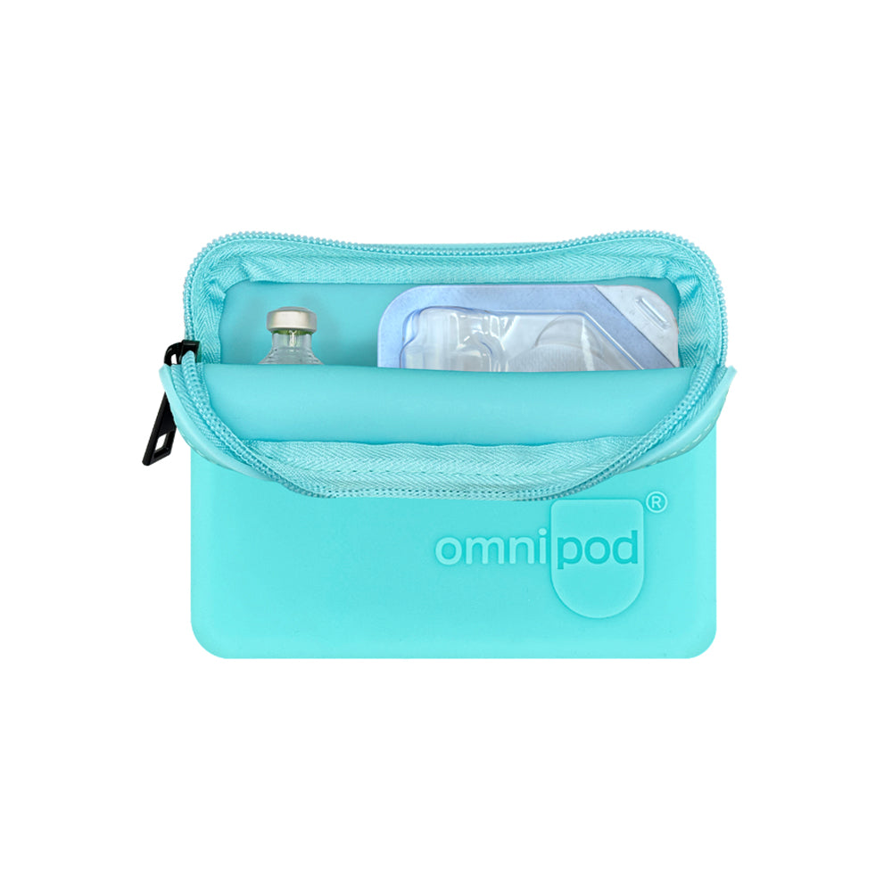 Set up with pod and insulin: The aqua Omnipod® protective travel case opened to reveal an Omnipod® insulin pod and an insulin vial placed inside, demonstrating the case's organized storage capabilities.