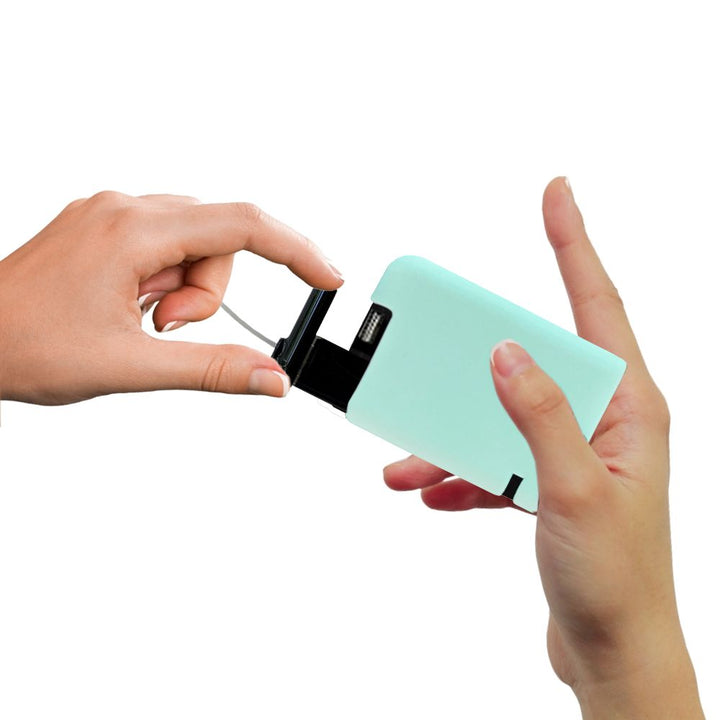 Hand pulling out Tandem cartridge with aqua protective silicone case on it.