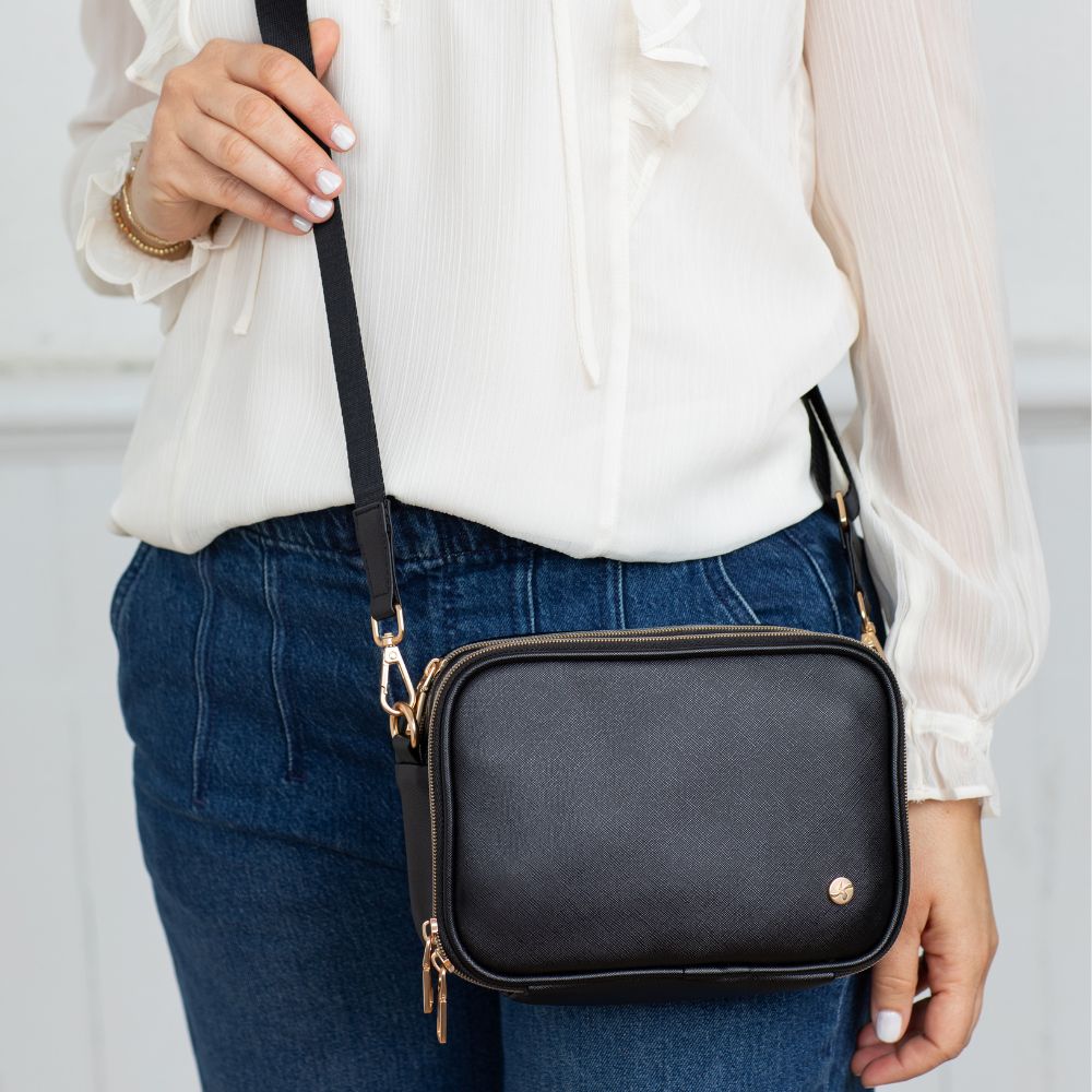 Woman wearing the Black Essential Diabetes Purse as a crossbody, showcasing its sleek, hands-free design and adjustable strap.