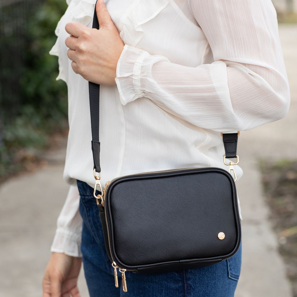 Woman wearing the Black Essential Diabetes Purse as a crossbody, showcasing its sleek, hands-free design and adjustable strap.
