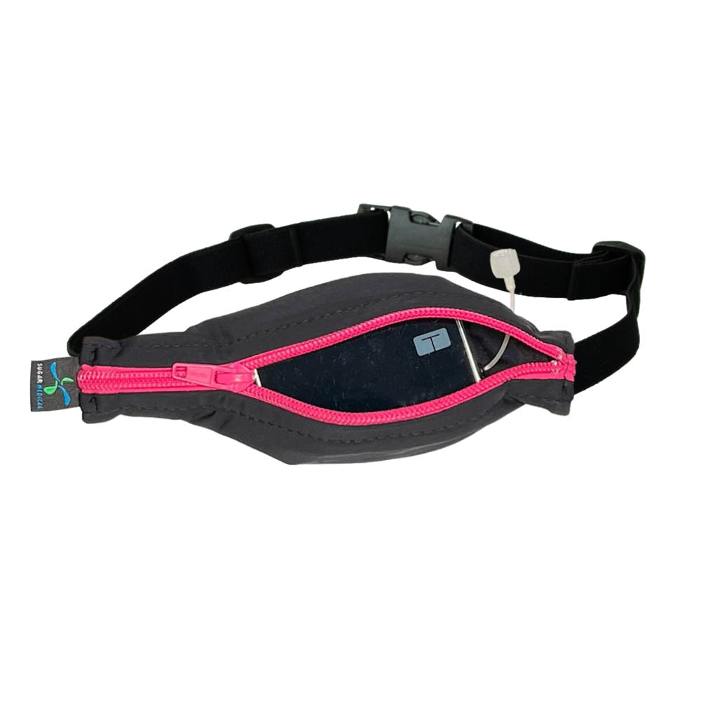 Kids black with pink zipper SPI belt open with Tandem pump inside and tubbing coming out the side hole.