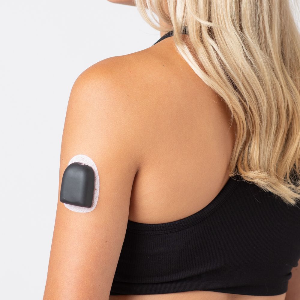 A woman wearing a black PumpPOP on the outside of her upper left arm