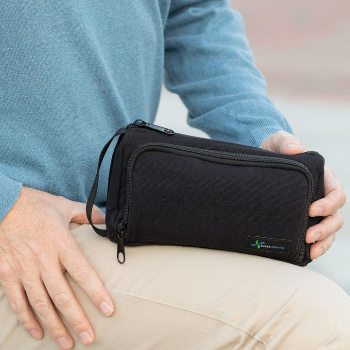 A man holding Insulated Diabetes Insulin Supply Case in black in his hands.
