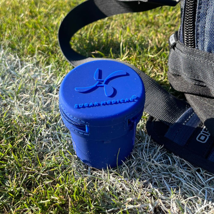 Blue Dexcom G7 Protective Travel Case on sports field protecting the Dexcom 7 inserter.