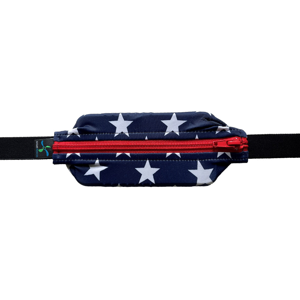 Kids blue with white stars and red zipper SPI belt closed with Omnipod 5 controller inside.