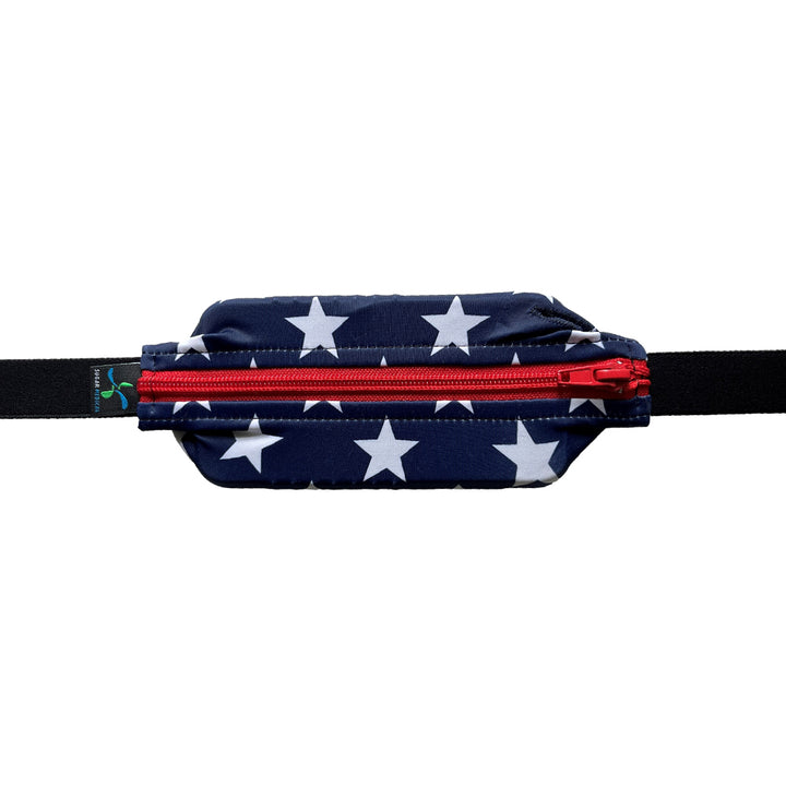 Kids blue with white stars and red zipper SPI belt closed with Omnipod 5 controller inside.