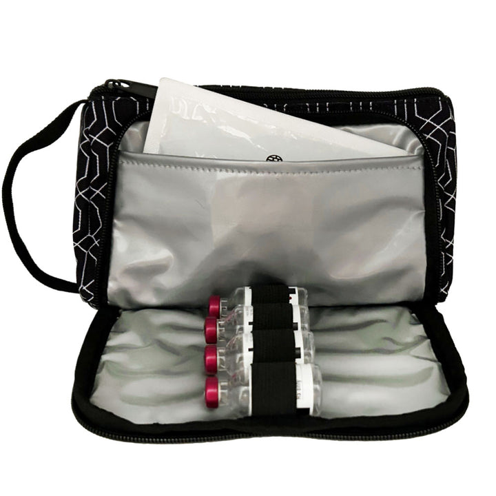 A black and white geometric pattern Insulated Diabetes Insulin Supply Case with insulated pocket open and an ice pack in slip pocket and four insulin vials secured in loops.