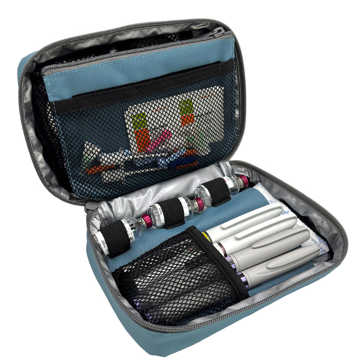 The back section of the steel blue diabetes organizer has three loops to secure insulin vials and mesh pocket that fits four insulin pens.