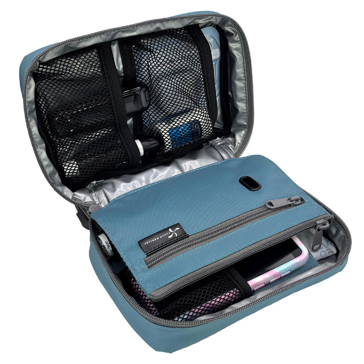 The front section of the steel blue diabetes organizer has three mesh pockets to secure your diabetic supplies