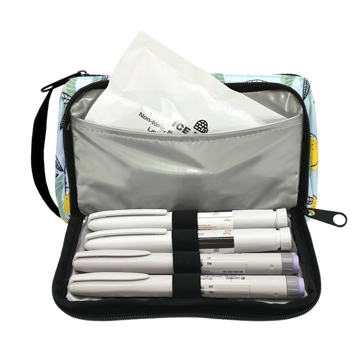 A yellow and blue lemon pattern Insulated Diabetes Insulin Supply Case with insulated pocket open and an ice pack in slip pocket and four insulin pens secured in loops.