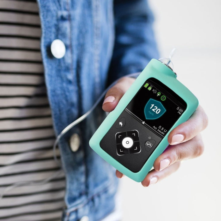 Women holding Ocean Medtronic Insulin Pump Gel Skin with Medtronic pump in it.