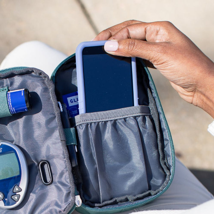 Omnipod 5 device with Sugar Medical Protective gel skin cover in a pocket of a Omnipod diabetes supply case.