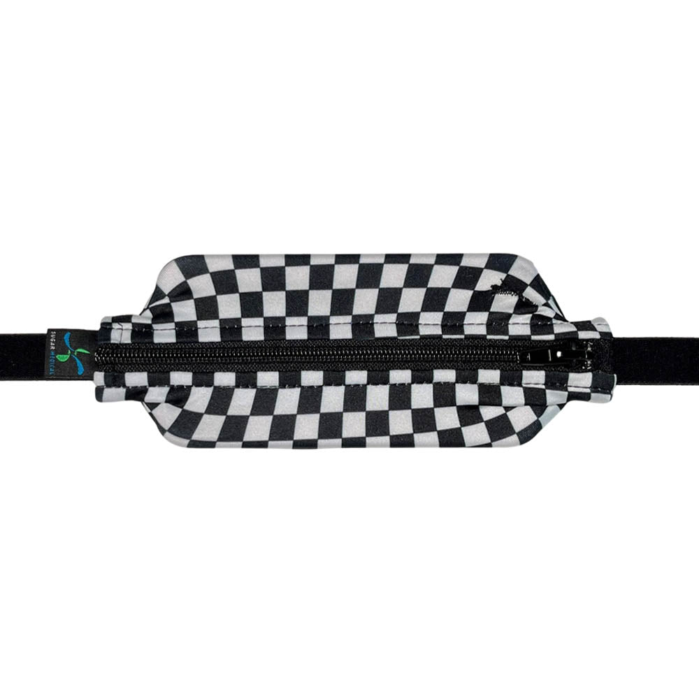 Kids black and white checkered patter with black zipper SPI belt closed with Omnipod 5 controller.
