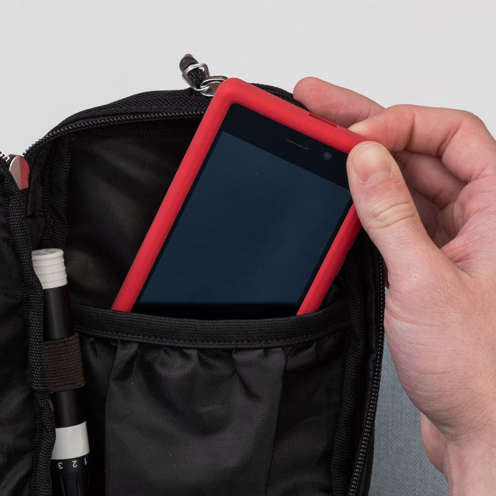 Inside of an Omnipod supply case showing a Omnipod Dash with a protective case on in the pocket.