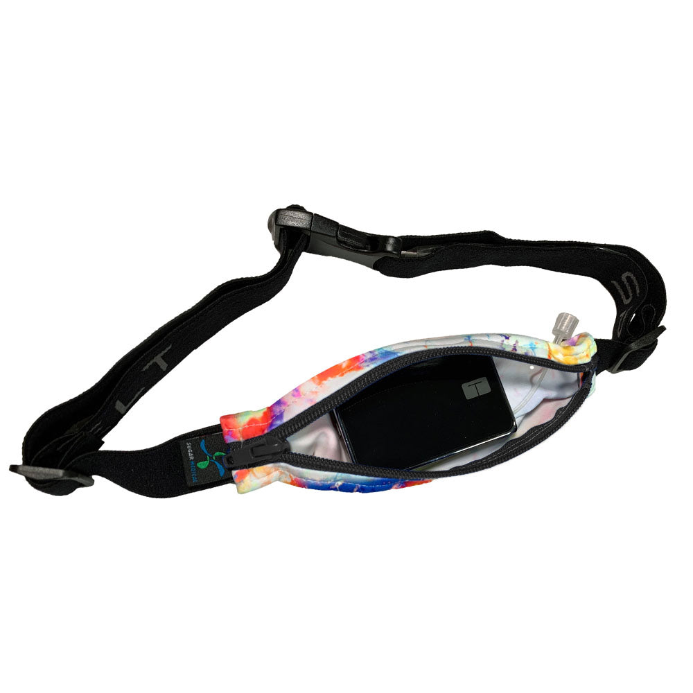 white stretchy waist belt with rainbow tie dye pattern unzipped with insulin pump shown along with tubing coming out of the slit on the back side for easy access.