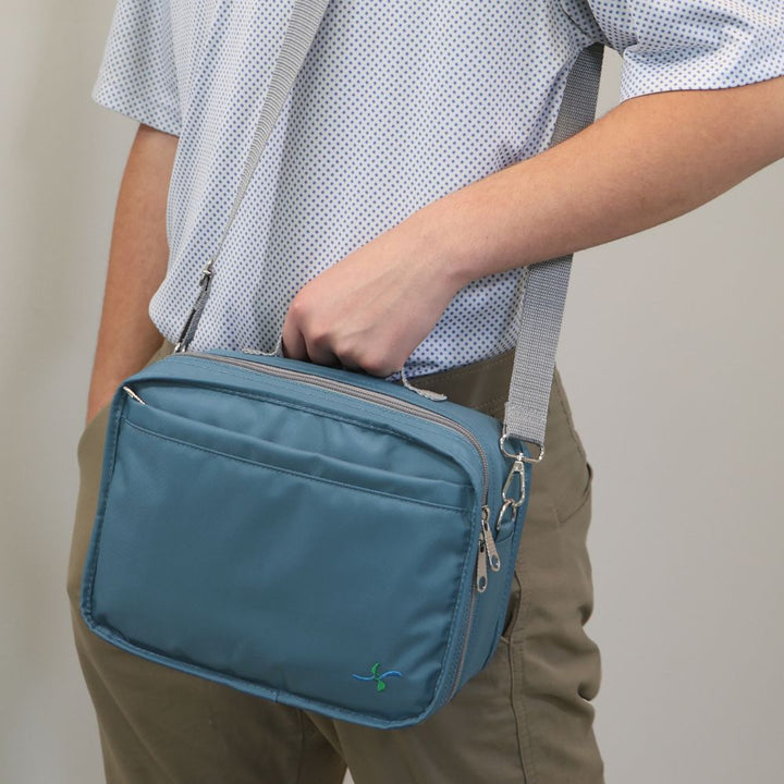 Man holding the Steel Blue Diabetes Travel bag on his shoulder.