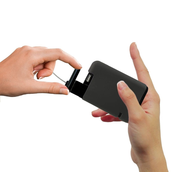 Hand pulling out Tandem cartridge with black protective silicone case on it.