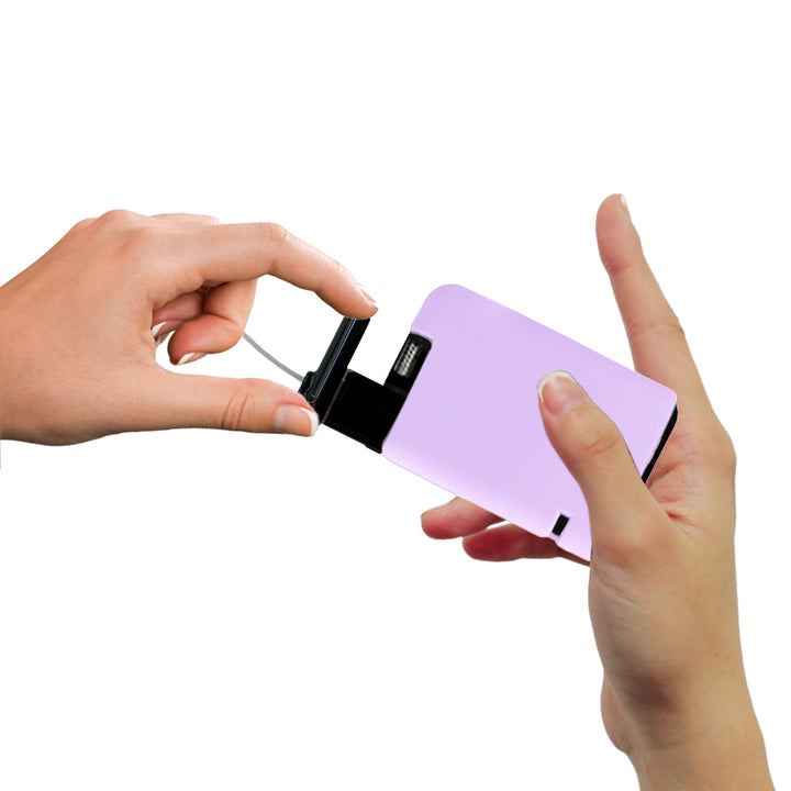 Hand pulling out Tandem cartridge with lavender protective silicone case on it.