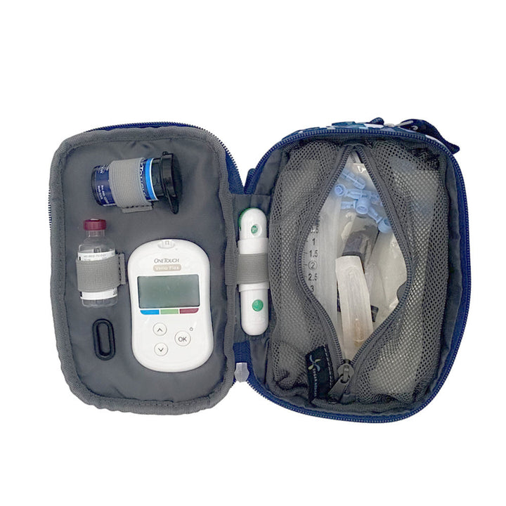 Tandem supply case in blue floral opened flat with inside set up containing glucose meter, test strips, lancet, and insulin vial on the left and a large mesh pocket on the right with extra supplies.
