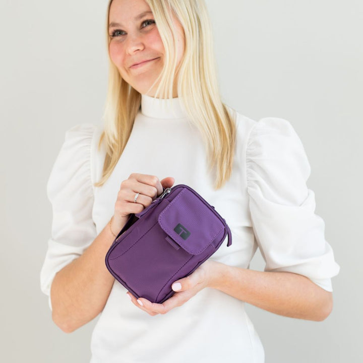 Woman in white shirt holding deep purple tandem supply case