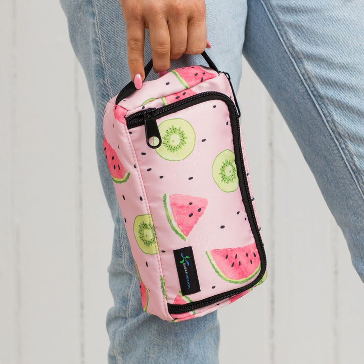 A women standing holding the pink watermelon pattern Insulated Diabetes Insulin Supply Case by the handle.