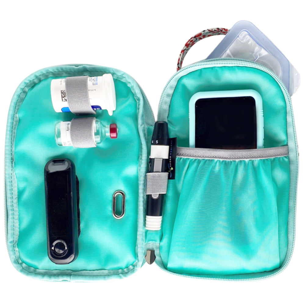 Lily middle section open flat with diabetes testing supplies and Omnipod 5 controller in pocket. 