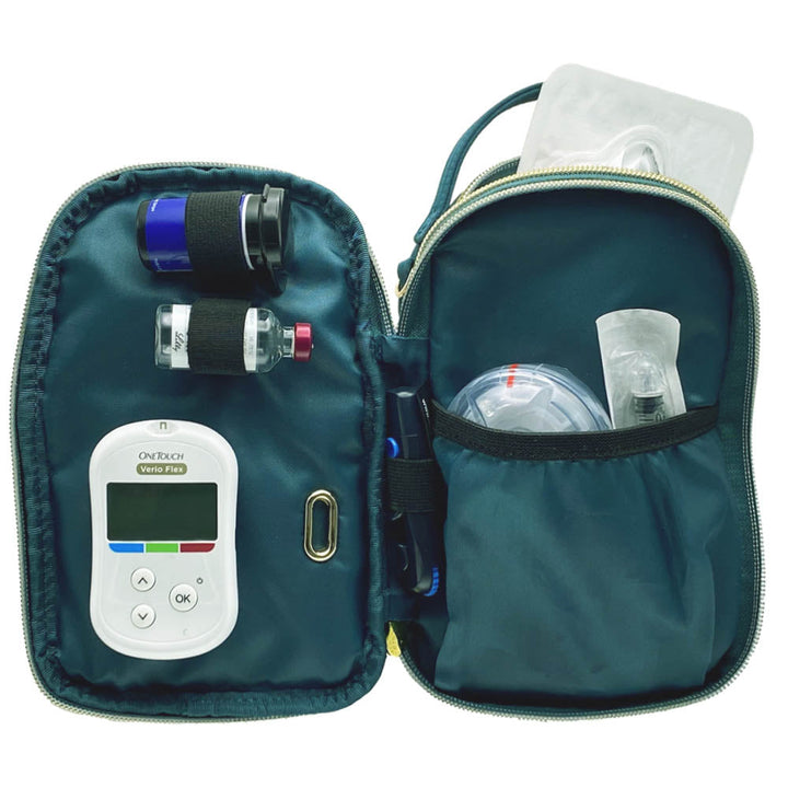 Meredith diabetes purse with Medtronic insulin pump supplies in middle unzipped center section of the purse.