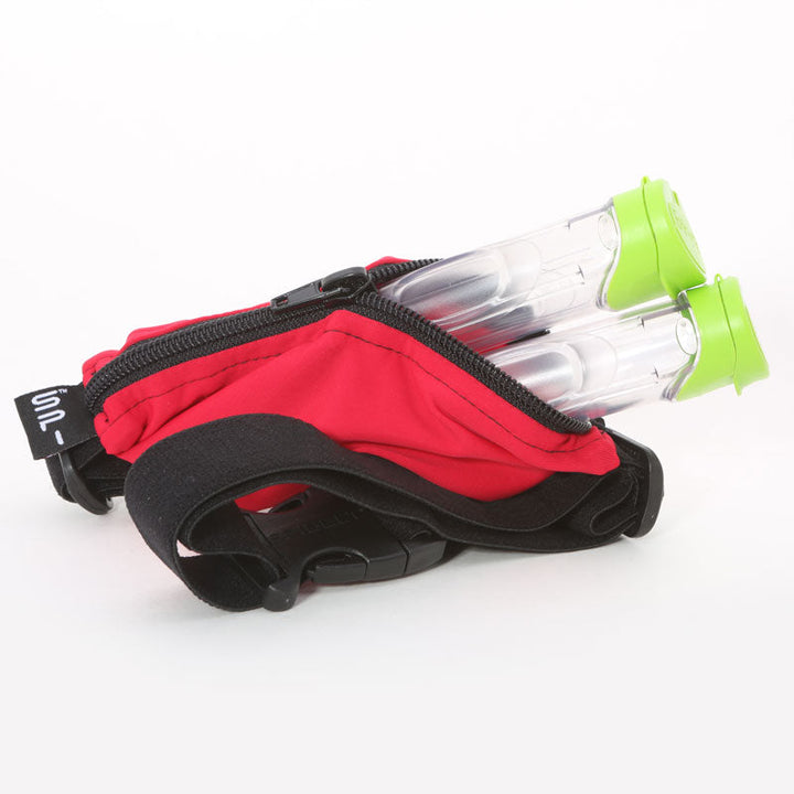 A red SPI belt open with two medical vials in the pocket.