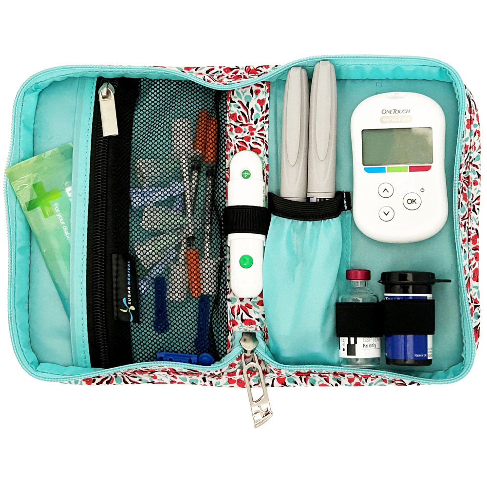 Sugar Medical Diabetes Supply Case II white with teal and red mini flowers inside set up with glucose meter, test strips, lancet, insulin pens and wipes.