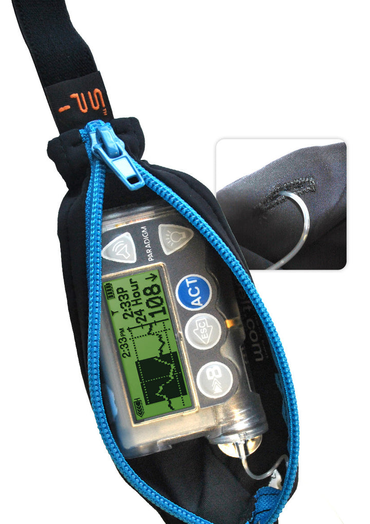 Kids black with blue zipper SPI belt open with Medtronic pump inside and tubbing coming out the side hole.