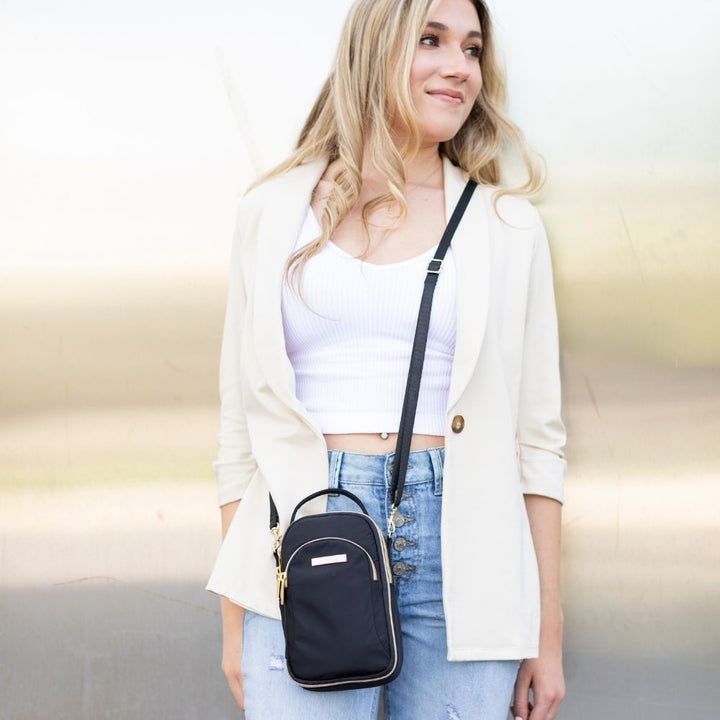 Woman wearing the black nylon diabetes purse crossbody on one shoulder leaving her hands-free.