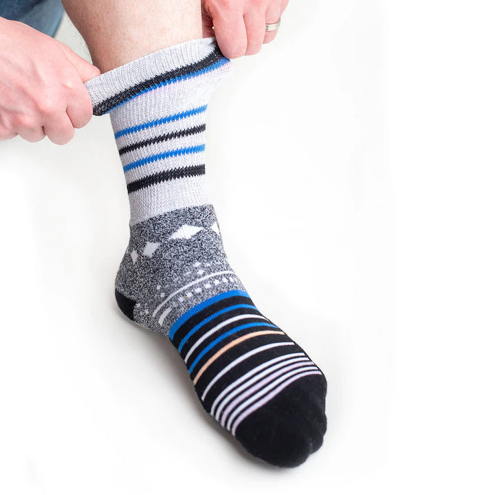 A person pulling on their foot a Black Star Dr. Segal's Premium Diabetic Sock.