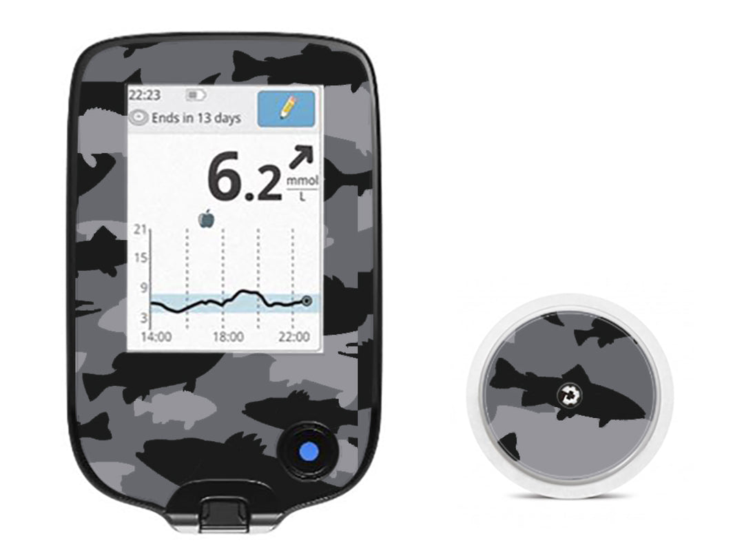 A fun sticker that has black and grey fish in a camouflage pattern on the Libre device and does not obstruct buttons or sensors.