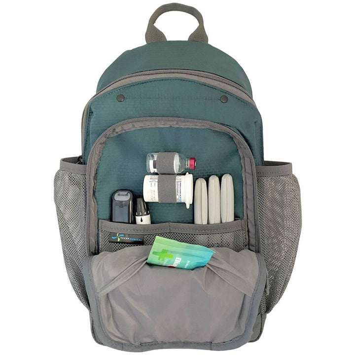 Diabetes Insulated Sling Backpack in green front compartment set up with glucose meter, test strips, insulin pens and lancet.