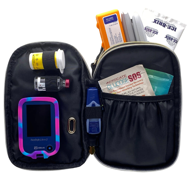 Black supply purse with center compartment unzipped with glucose testing supplies in elastic loops. Nylon pocket on the right shows Glucose SOS and finger wipes.
