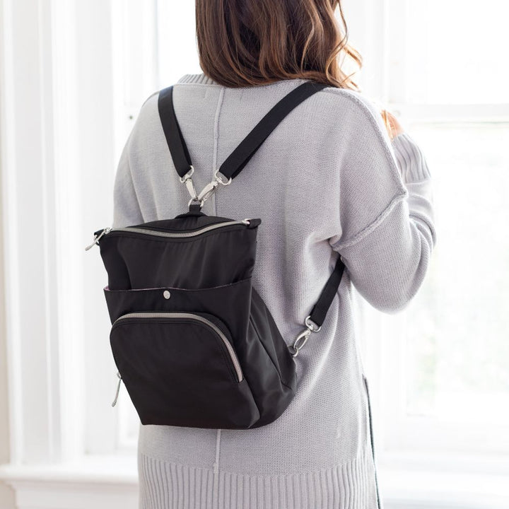 Women wearing Diabetes Nylon Backpack in black on back with two straps on women's back.