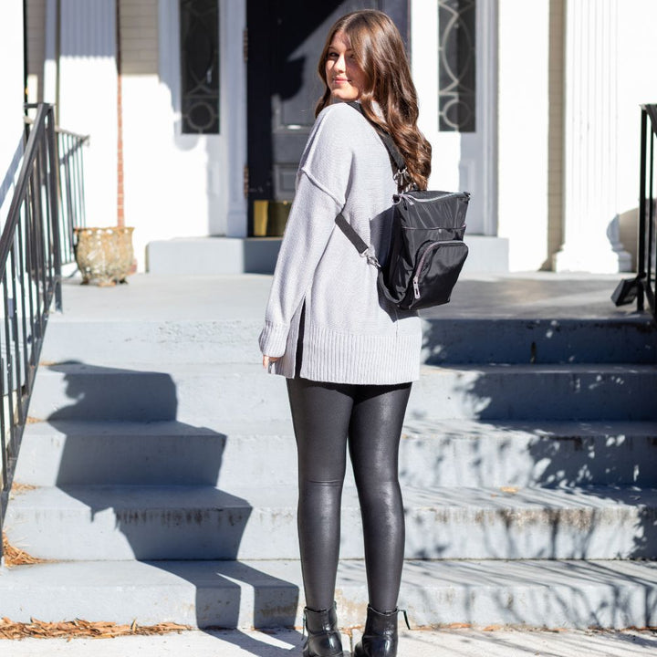 Women wearing Diabetes Nylon Backpack in black on back with two straps on women's back.
