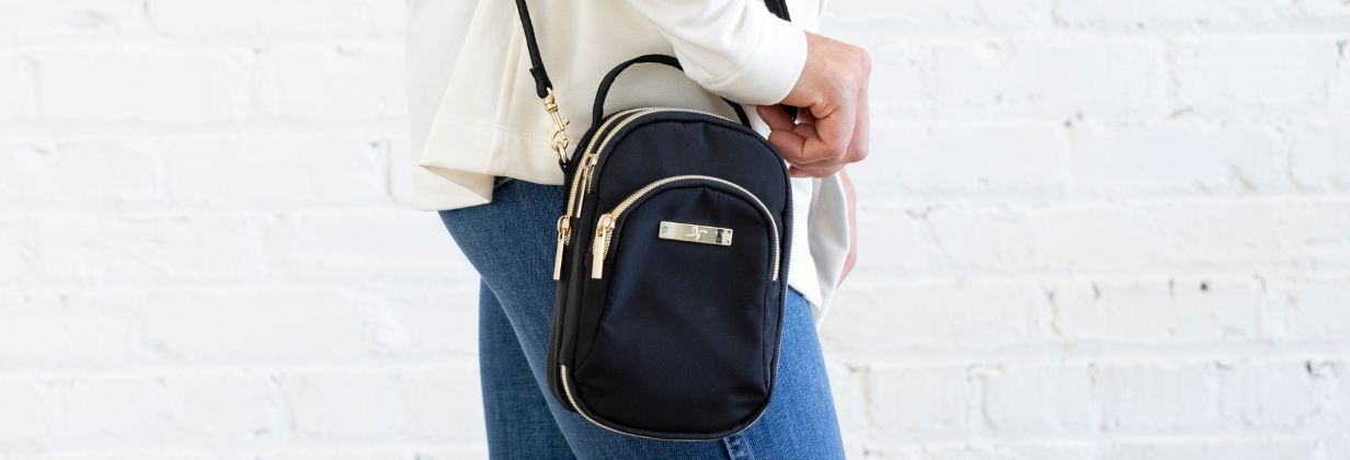Diabetes supply triple zip insulated purse lifestyle image in chloe.  Banner of women holding black diabetes supply purse.