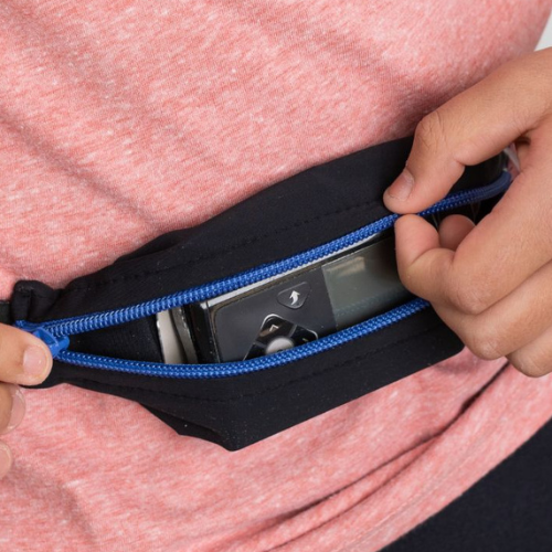 Boy wearing a kids SPI belt with a Tandem t:slim insulin pump inside