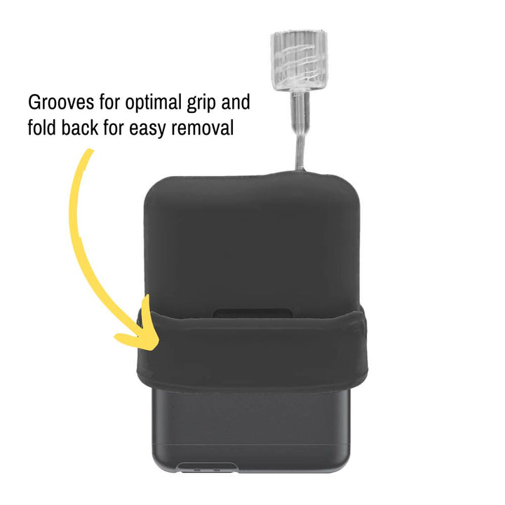 The black Mobi Tandem Gel Skin pulled up on the insulin pump showing grooves for optimal grip and fold back for easy removal. 