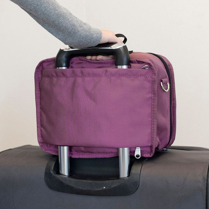 Diabetes Insulated Travel Bag in orchid 
carried on a suitcase and being held by the handle. 
