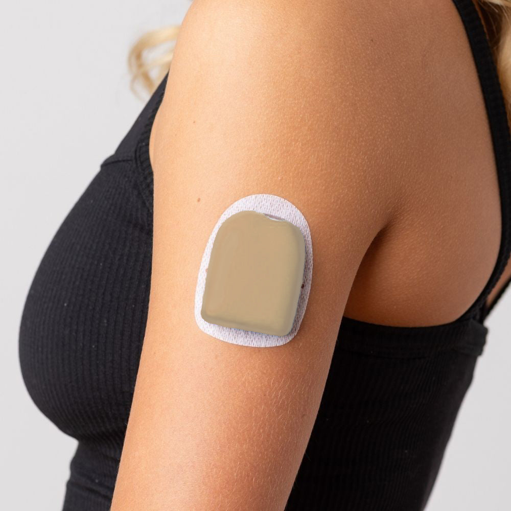 A close-up picture of a woman wearing the caramel PumpPOP on the outside of her upper left arm